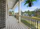 Inviting covered porch featuring a wooden deck, black railings, and hanging plants, perfect for outdoor relaxation at 8618 Whitehawk Hill Rd, Waxhaw, NC 28173