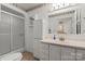 Bathroom featuring single sink vanity, frosted shower with sliding door, and floral decor at 902 Cornelius Rd, Mooresville, NC 28117