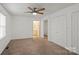 Spacious bedroom with carpet, ceiling fan, window, and double door closet at 902 Cornelius Rd, Mooresville, NC 28117