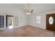 Bright bedroom with carpet, ceiling fan, and entry door at 902 Cornelius Rd, Mooresville, NC 28117