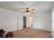 Spacious carpeted bedroom featuring three interior doors and a window at 902 Cornelius Rd, Mooresville, NC 28117