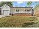 Charming ranch-style home features a welcoming front porch and an attached two-car garage at 902 Cornelius Rd, Mooresville, NC 28117