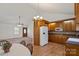 Eat-in kitchen featuring wooden cabinets, white refrigerator, and a view to the living area at 902 Cornelius Rd, Mooresville, NC 28117