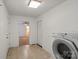 Laundry room with tile flooring, washer, dryer, and access to bedroom at 902 Cornelius Rd, Mooresville, NC 28117