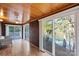 Cozy sun room with brick walls, wood paneled ceiling, and lake views at 902 Cornelius Rd, Mooresville, NC 28117
