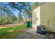 View of back of house showcasing lawn, trees and fence at 9036 Four Mile Creek Rd, Charlotte, NC 28277