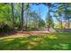 Large backyard with mature trees and partial fence line at 9036 Four Mile Creek Rd, Charlotte, NC 28277