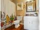 Bathroom with decorative shower curtain, white vanity, wood-look flooring and neutral paint at 9036 Four Mile Creek Rd, Charlotte, NC 28277