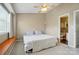 Bright bedroom with a ceiling fan, large window, and an ensuite bathroom at 9036 Four Mile Creek Rd, Charlotte, NC 28277