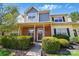 Charming townhome with a brick facade, lush landscaping, and inviting front porch at 9036 Four Mile Creek Rd, Charlotte, NC 28277