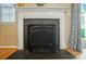 Close-up of a fireplace featuring an ornate mantel, black slate and a decorative fire screen at 9036 Four Mile Creek Rd, Charlotte, NC 28277