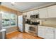 Bright kitchen featuring stainless steel appliances and a large sunny window at 9036 Four Mile Creek Rd, Charlotte, NC 28277