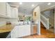 Open kitchen with stainless appliances and a view of the living space and staircase at 9036 Four Mile Creek Rd, Charlotte, NC 28277