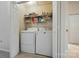 Picture of the laundry room featuring a washer and dryer with shelving above at 9036 Four Mile Creek Rd, Charlotte, NC 28277