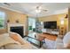 Living room featuring a cozy fireplace, hardwood flooring and sliding glass door with access to the outdoors at 9036 Four Mile Creek Rd, Charlotte, NC 28277