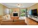 Inviting living room with a fireplace, sliding glass door to the backyard, and stylish furnishings at 9036 Four Mile Creek Rd, Charlotte, NC 28277