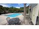 Community pool with an outdoor shower surrounded by lounge chairs and lush landscaping near a charming green building at 9036 Four Mile Creek Rd, Charlotte, NC 28277
