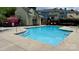 Inviting community pool with steps, surrounded by lounge chairs near colorful townhomes at 9036 Four Mile Creek Rd, Charlotte, NC 28277