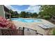 Inviting community pool surrounded by lush landscaping, lounge chairs, and townhomes at 9036 Four Mile Creek Rd, Charlotte, NC 28277