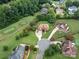 Aerial view showcases a beautiful home on a large lot, backing onto a lush golf course at 9427 Bethesda Ct, Matthews, NC 28104