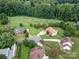 A high aerial view showcases a neighborhood with golf course frontage and lush surroundings at 9427 Bethesda Ct, Matthews, NC 28104