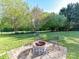 Backyard with fire pit and seating area that's great for relaxing in the yard at 9427 Bethesda Ct, Matthews, NC 28104