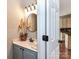 Charming bathroom with granite countertops, a decorative mirror, and stylish fixtures at 9427 Bethesda Ct, Matthews, NC 28104