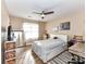 Comfortable bedroom with ceiling fan, hardwood floors, and plenty of natural light at 9427 Bethesda Ct, Matthews, NC 28104