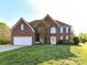 Charming two-story brick home with manicured lawn, attached garage, and a welcoming front entrance at 9427 Bethesda Ct, Matthews, NC 28104