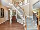 Spacious foyer featuring hardwood flooring, staircase, and stylish decor leading to other rooms at 9427 Bethesda Ct, Matthews, NC 28104