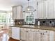 Charming kitchen with decorative backsplash, granite counters, and ample natural light at 9427 Bethesda Ct, Matthews, NC 28104