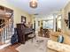 Inviting living room features a piano, sofa, and elegant decor, creating a cozy atmosphere at 9427 Bethesda Ct, Matthews, NC 28104