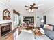 Sun-lit living room with fireplace, plush rug, hardwood flooring, and a view into the adjacent kitchen at 9427 Bethesda Ct, Matthews, NC 28104