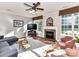 Bright living room featuring hardwood floors, large windows, a cozy fireplace, and comfortable seating at 9427 Bethesda Ct, Matthews, NC 28104