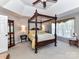 Bright main bedroom with natural light, a ceiling fan, and a stately four-poster bed at 9427 Bethesda Ct, Matthews, NC 28104