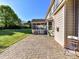 Paver patio offers ample room for outdoor dining or relaxation with adjacent lush lawn at 9427 Bethesda Ct, Matthews, NC 28104