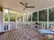 Inviting screened porch with ceiling fan, perfect for enjoying the outdoors at 9427 Bethesda Ct, Matthews, NC 28104