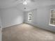 Bright bedroom with neutral carpet and two windows allowing plenty of natural light at 9930 Birch Knoll Ct, Charlotte, NC 28213
