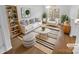 Staged living room with modern decor, including a plush sofa, stylish rug, and ample natural light at 9930 Birch Knoll Ct, Charlotte, NC 28213