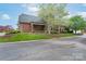 Charming brick home with mature landscaping, a well-manicured lawn, and a welcoming front entrance at 104 Hallmark Xing, Rock Hill, SC 29732