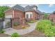 Exterior view of a brick home featuring lush landscaping, a walkway, and a well-maintained garden at 104 Hallmark Xing, Rock Hill, SC 29732