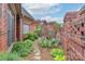 Landscaped garden with lush greenery, flowering plants, and a brick privacy wall, offering a serene outdoor space at 104 Hallmark Xing, Rock Hill, SC 29732