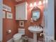 Charming powder room featuring a pedestal sink, toilet, and decorative mirror at 104 Hallmark Xing, Rock Hill, SC 29732