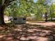 Large backyard featuring a storage shed, lush trees, and ample green space at 109 Barrett Rd, Cherryville, NC 28021