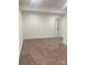 Large bedroom with plush carpet and ample space, featuring a bright white door at 109 Barrett Rd, Cherryville, NC 28021