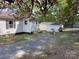 Rear of traditional home, garage, patio, and attractive landscaping with mature trees at 109 Barrett Rd, Cherryville, NC 28021