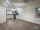 Modern kitchen with white cabinets, stainless steel appliances, granite counters, and wood-look flooring at 109 Barrett Rd, Cherryville, NC 28021