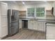 Bright kitchen featuring stainless steel appliances, white cabinets, granite countertop, and window at 109 Barrett Rd, Cherryville, NC 28021