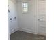 Clean utility room offers tile flooring, neutral walls, and convenient access to utilities at 109 Barrett Rd, Cherryville, NC 28021