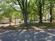 Street view of traditional home and yard with mature trees and detached outbuildings at 109 Barrett Rd, Cherryville, NC 28021